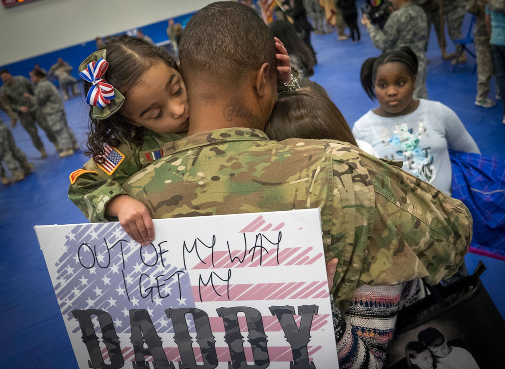 Emilee King, 3, kisses her father, Army Staff Sgt. Demarcus King, assigned to the 98th Maintenance Company, 17th Combat Sustainment Support Battalion, U.S. Army Alaska, after a redeployment ceremony to reunite Soldiers with their families at the Buckner Physical Fitness Center, Wednesday on Joint Base Elmendorf-Richardson.  (U.S. Air Force photo/Justin Connaher)