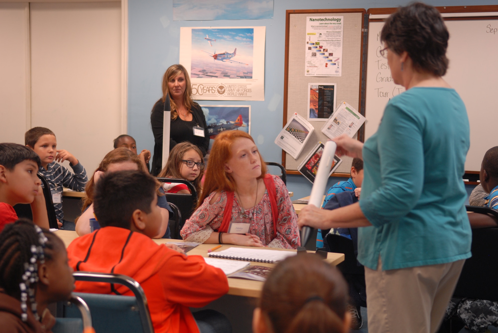 Fifth grade students, from Porter Elementary School in Macon, listen to their teacher as she explains how to assemble the rockets they will all launch later. (U.S. Air Force photo by Misuzu Allen)