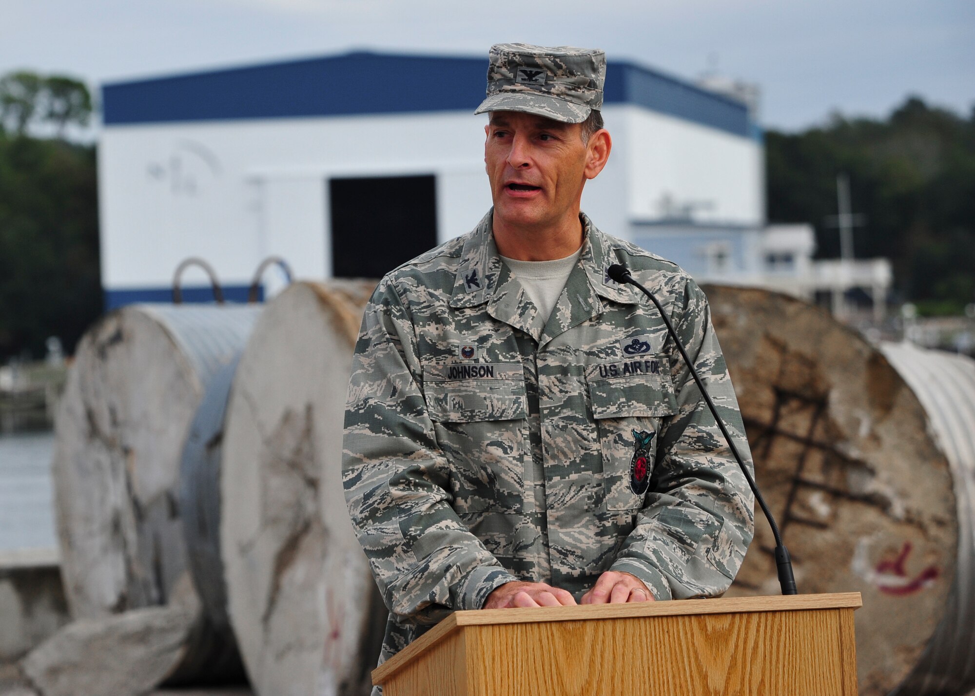 Col. Craig Johnson, 96th Civil Engineer Group commander, speaks during a Community Partnership Program event to donate waste concrete targets Nov. 5 near Eglin Air Force Base, Fla. The 2,000 tons of concrete targets will be used to create an artificial reef in the Gulf of Mexico and was donated to Okaloosa County by Eglin’s Air Force Research Lab. (U.S. Air Force photo/Ilka Cole) 