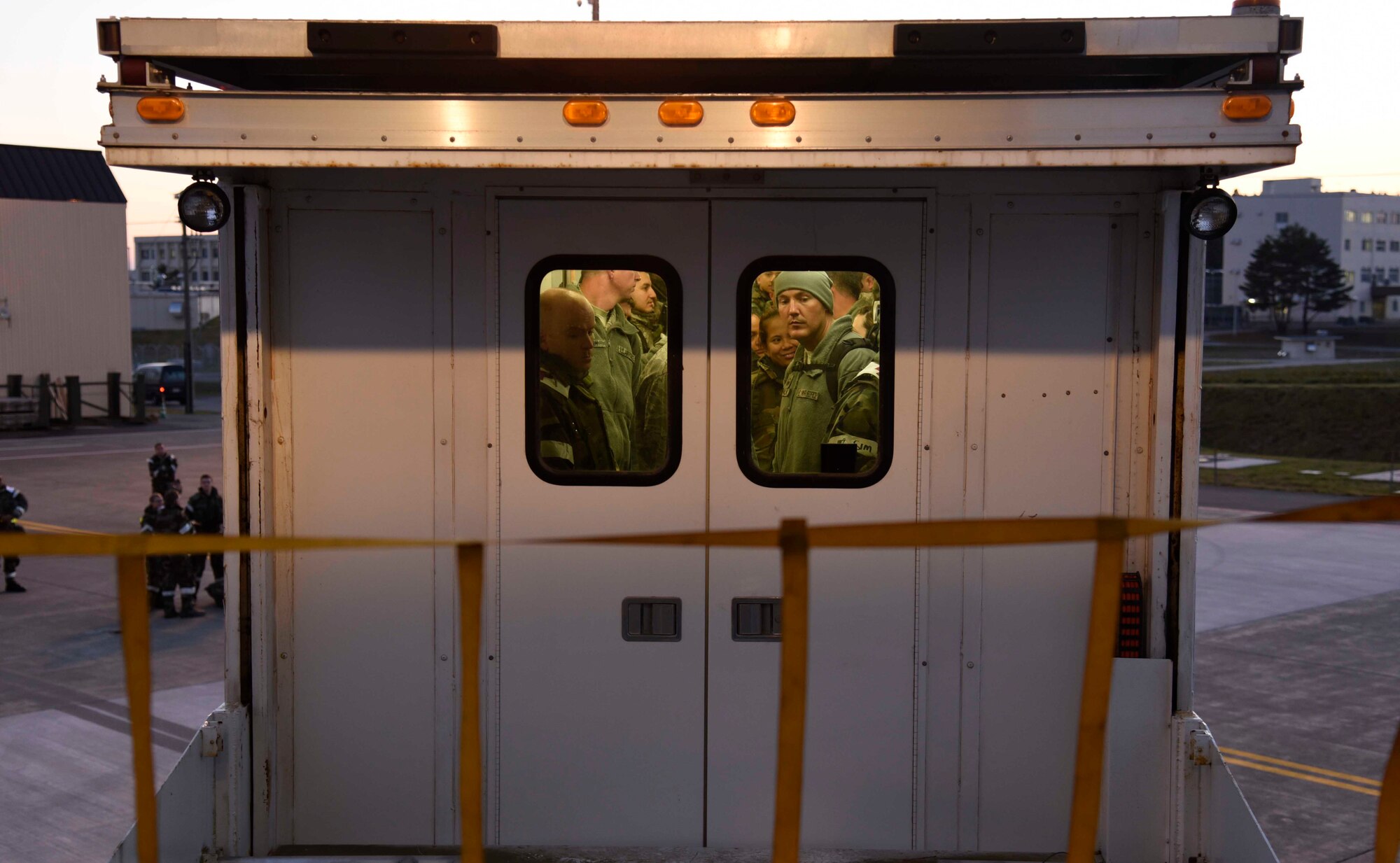 U.S. Air Force Airmen are lowered to the ground in a high deck patient loading platform at Misawa Air Base, Japan, Nov. 4, 2015. The lift is used to carry patients safely from aircraft like the KC-135 Stratotanker. (U.S. Air Force photo by Airman 1st Class Jordyn Fetter/Released)