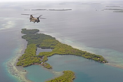 A U.S. Army CH-47 Chinook helicopter flies over the coast of Belize, Oct. 25, 2015 en route to a drug eradication mission with Belizean security forces. The Chinook and its aircrew provided a means for the eradication teams to access various areas in the country to help combat illegal trafficking and cultivation of narcotics. (U.S. Air Force photo by Senior Airman Westin Warburton/Released)