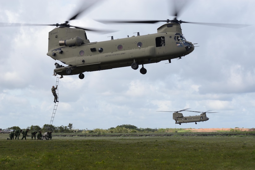 Two U.S. Army CH-47 Chinooks provide Belizean security forces an opportunity to practice climbing in and out of the aircraft, Oct. 26, 2015, before using the skills learned to eradicate marijuana fields in Belize. The Belizean security forces personnel conducted initial surveillance of the fields and the Army provided vital airlift support, giving the Belizeans the lead in the intelligence gathering of the four-day operation. (U.S. Air Force photo by Senior Airman Westin Warburton/Released)