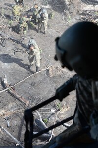 U.S. Army Sgt. Dane Rogge, 1-228 Aviation Regiment crew chief, drops a ladder from a CH-47 Chinook helicopter for Belizean forces to climb during a marijuana eradication mission, Oct. 27, 2015 in Belize. The four-day operation with the Belizean security forces and U.S. Army resulted in the eradication of over 50,000 marijuana plants and put the Belize forces at the head of the intelligence efforts for the operation with U.S. airlift supporting the effort. (U.S. Air Force photo by Senior Airman Westin Warburton/Released)