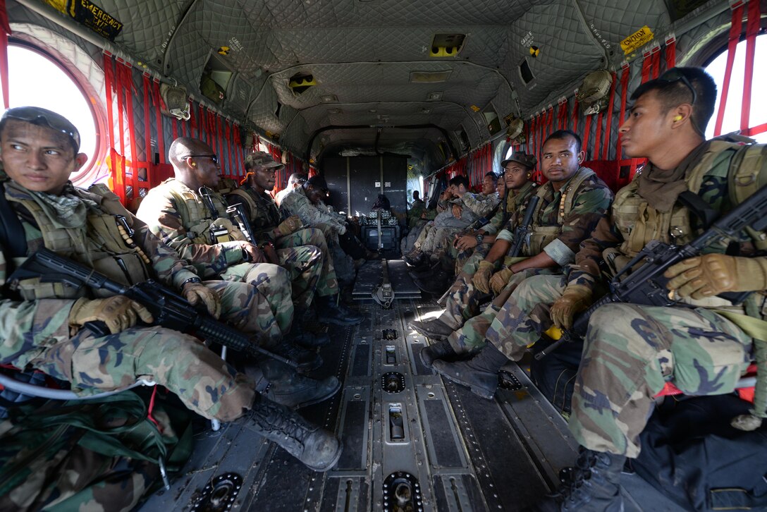 Belizean security forces members ride aboard a U.S. Army CH-47 Chinook helicopter during a marijuana eradication mission, Oct. 27, 2015, in Belize. The U.S. Army provided airlift capabilities to the Belizean security forces during the eradication of marijuana fields identified by Belizean Intelligence throughout the four-day operation. (U.S. Air Force photo by Senior Airman Westin Warburton/Released)