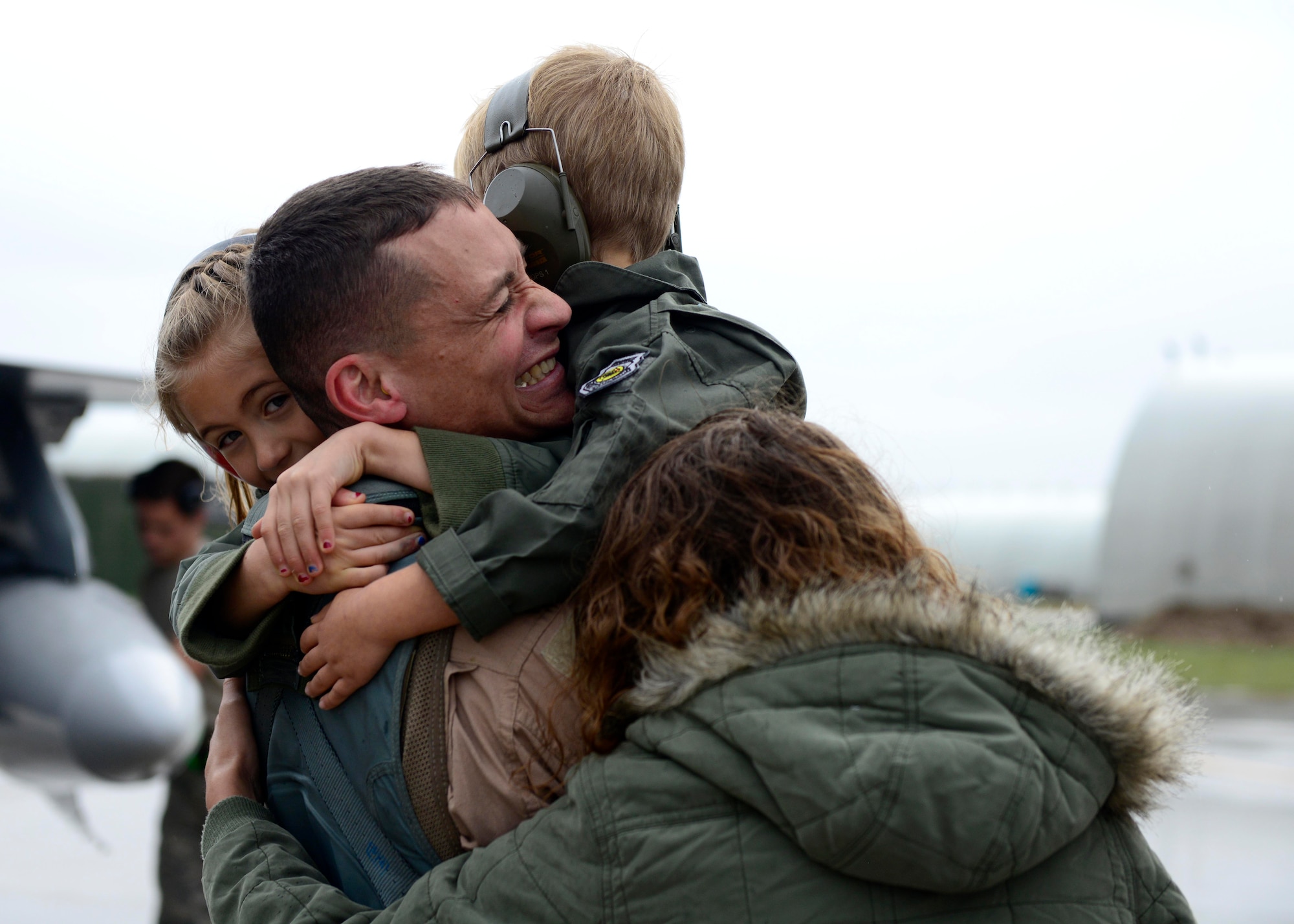 Family members welcome back 555th Fighter Squadron and Aircraft Maintenance Unit Airmen as they return from a deployment Oct. 29, 2015, at Aviano Air Base, Italy. The 555th FS and AMU deployed more than 300 maintenance and support personnel in support of Operation New Dawn. (U.S. Air Force photo by Senior Airman Areca T. Bell/Released)
