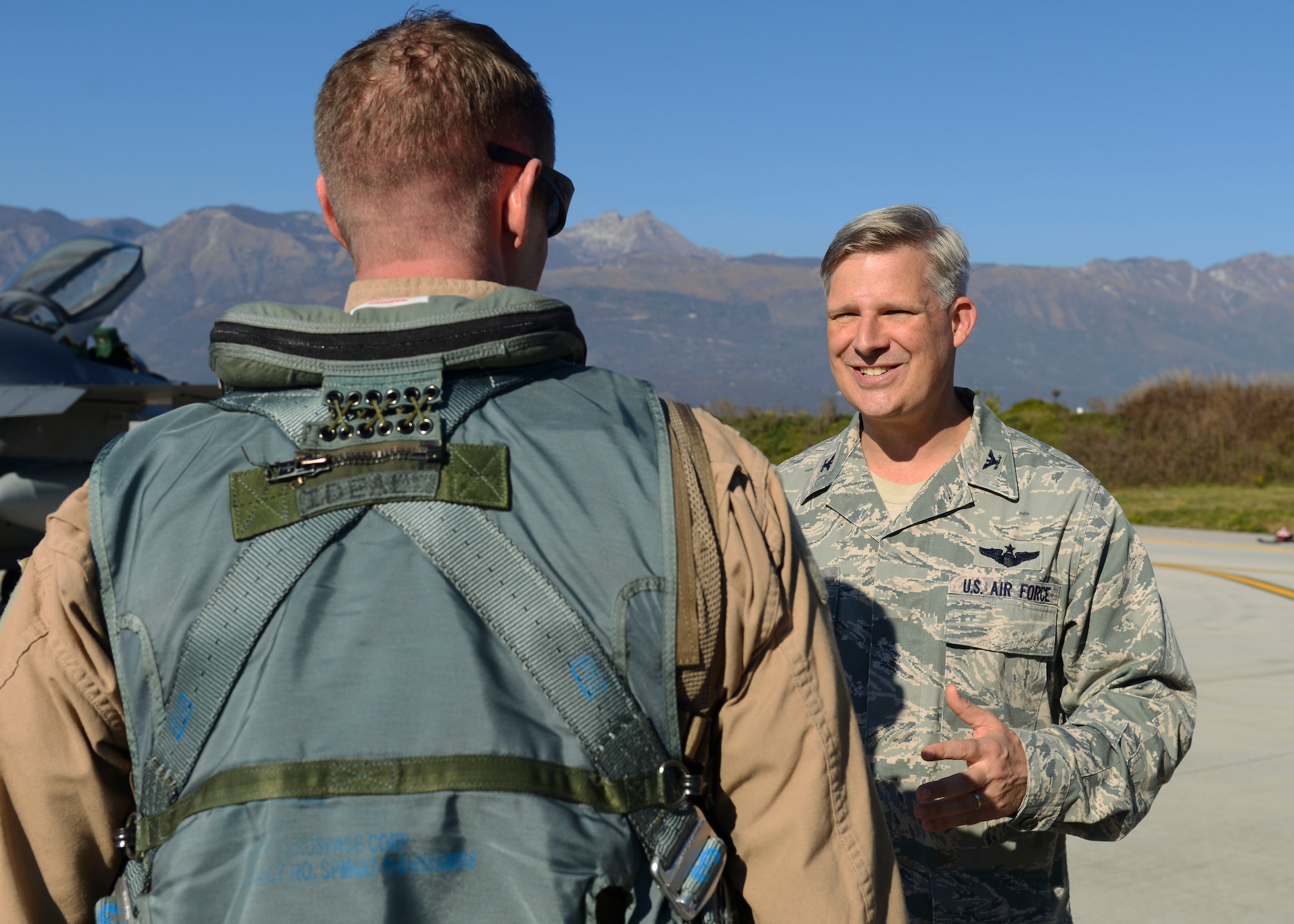 U.S. Air Force Col. Bryan Wolford, 31st Fighter Wing vice commander, welcomes back a 555th Fighter Squadron Airman after returning from a deployment, Nov. 3, 2015, at Aviano Air Base, Italy. The 555th FS and Aircraft Maintenance Unit deployed more than 300 maintenance and support personnel in support of Operation New Dawn. (U.S. Air Force photo by Senior Airman Austin Harvill/Released)