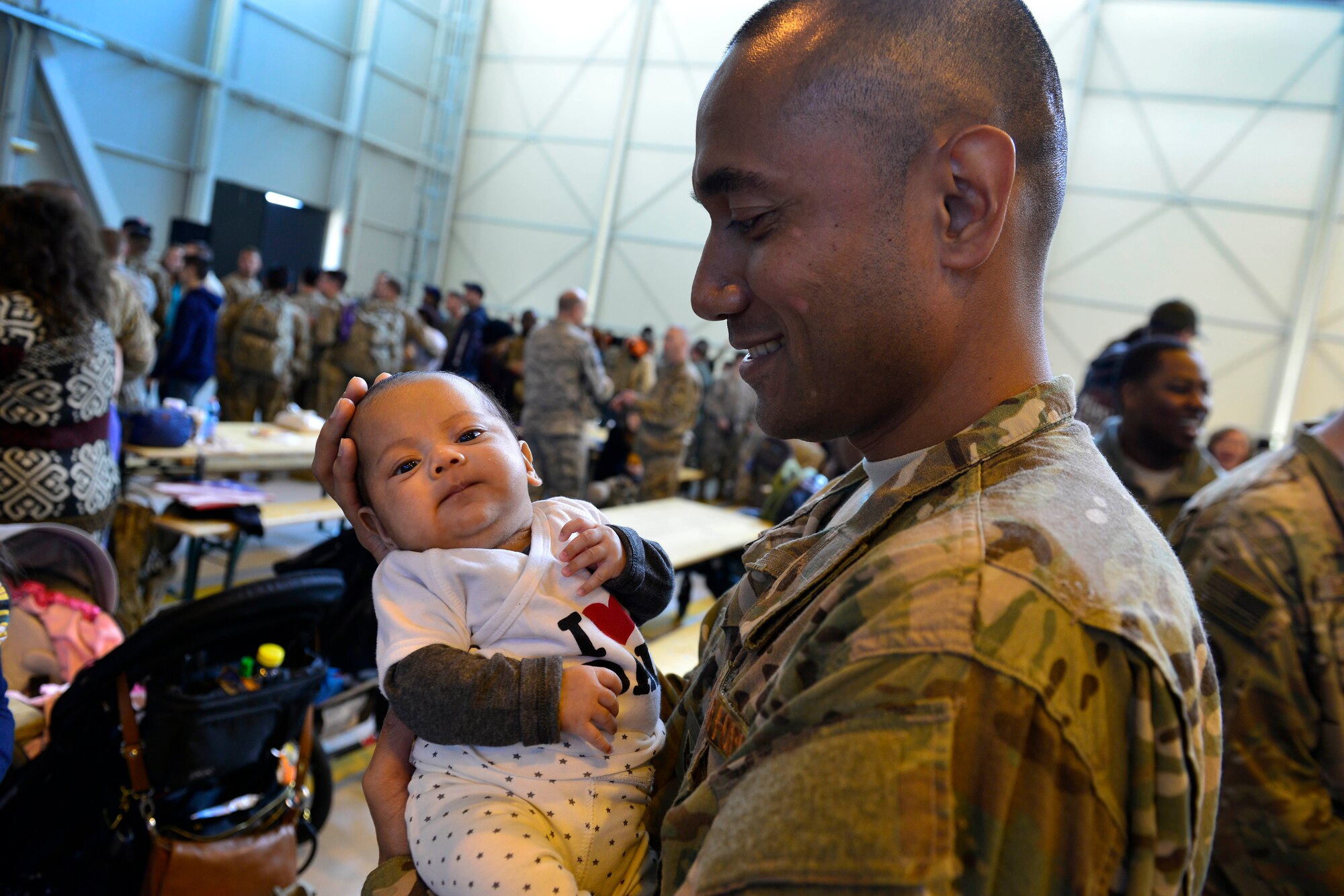Family members welcome back 555th Fighter Squadron and Aircraft Maintenance Unit Airmen as they return from a deployment, Nov. 5, 2015, at Aviano Air Base, Italy. The 555th FS and AMU deployed more than 300 maintenance and support personnel in support of Operation New Dawn. (U.S. Air Force photo by Airman 1st Class Cary Smith/Released)