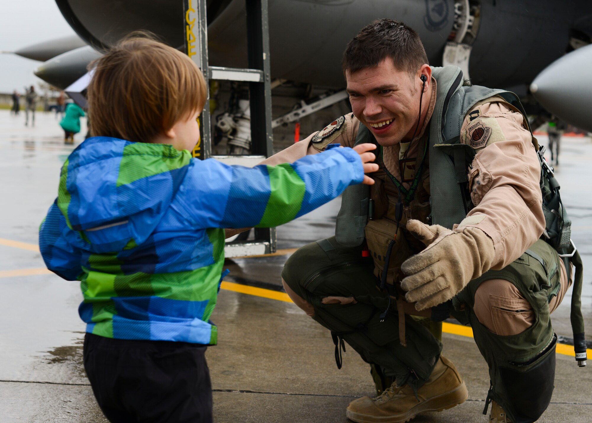 Family members welcome back 555th Fighter Squadron and Aircraft Maintenance Unit Airmen as they return from a deployment, Oct. 29, 2015, at Aviano Air Base, Italy. The 555th FS and AMU deployed more than 300 maintenance and support personnel in support of Operation New Dawn. (U.S. Air Force photo by Senior Airman Austin Harvill/Released)