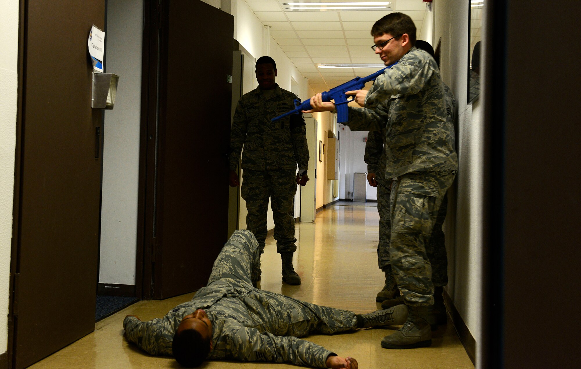 A student in the Expeditionary Active Shooter Training class checks on a fallen Airman during a simulated active shooter scenario Nov. 5, 2015, at Ramstein Air Base, Germany. The course is a requirement for deploying Airmen and includes a hands-on practical portion that allows the students to use the skills they were taught in the course. (U.S. Air Force photo/Airman 1st Class Tryphena Mayhugh)