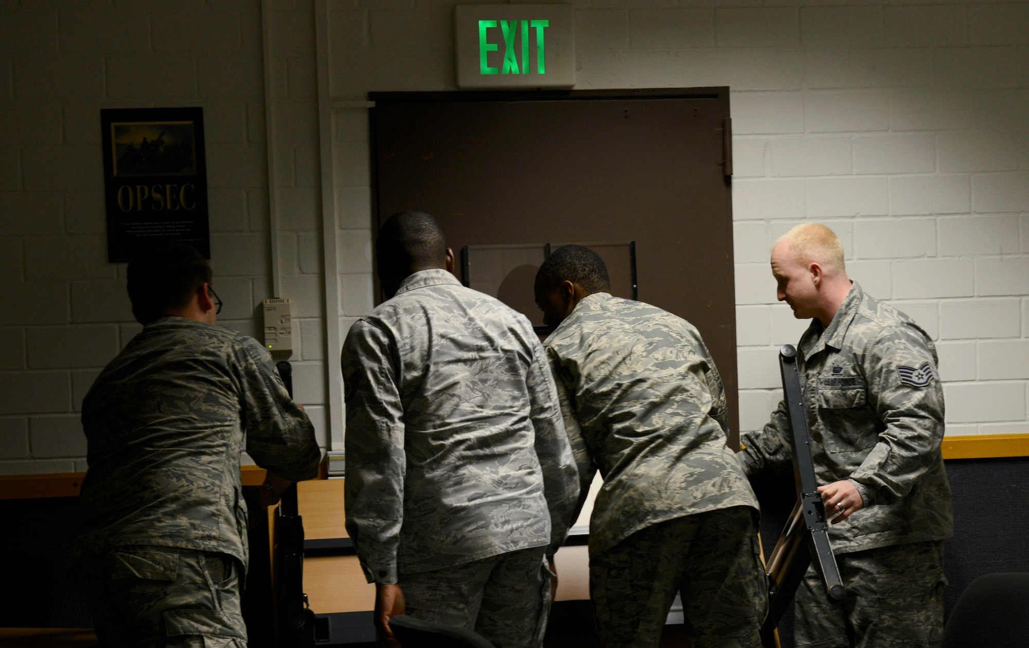 Students in the Expeditionary Active Shooter Training class barricade a door during a simulated active shooter scenario Nov. 5, 2015, at Ramstein Air Base, Germany. The E.A.S.T. class is a requirement for deploying Airmen and includes hands-on practical training to further prepare the student for a real active shooter situation. (U.S. Air Force photo/Airman 1st Class Tryphena Mayhugh)