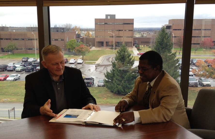 Dr. Todd Stewart, director and chancellor of the Air Force Institute of Technology, compares notes with Dr. Adedeji Badiru, dean of the Graduate School of Engineering and Management, after the ABET review of AFIT’s graduate-level engineering programs. (U.S. Air Force photo/ Sandy Simison) 