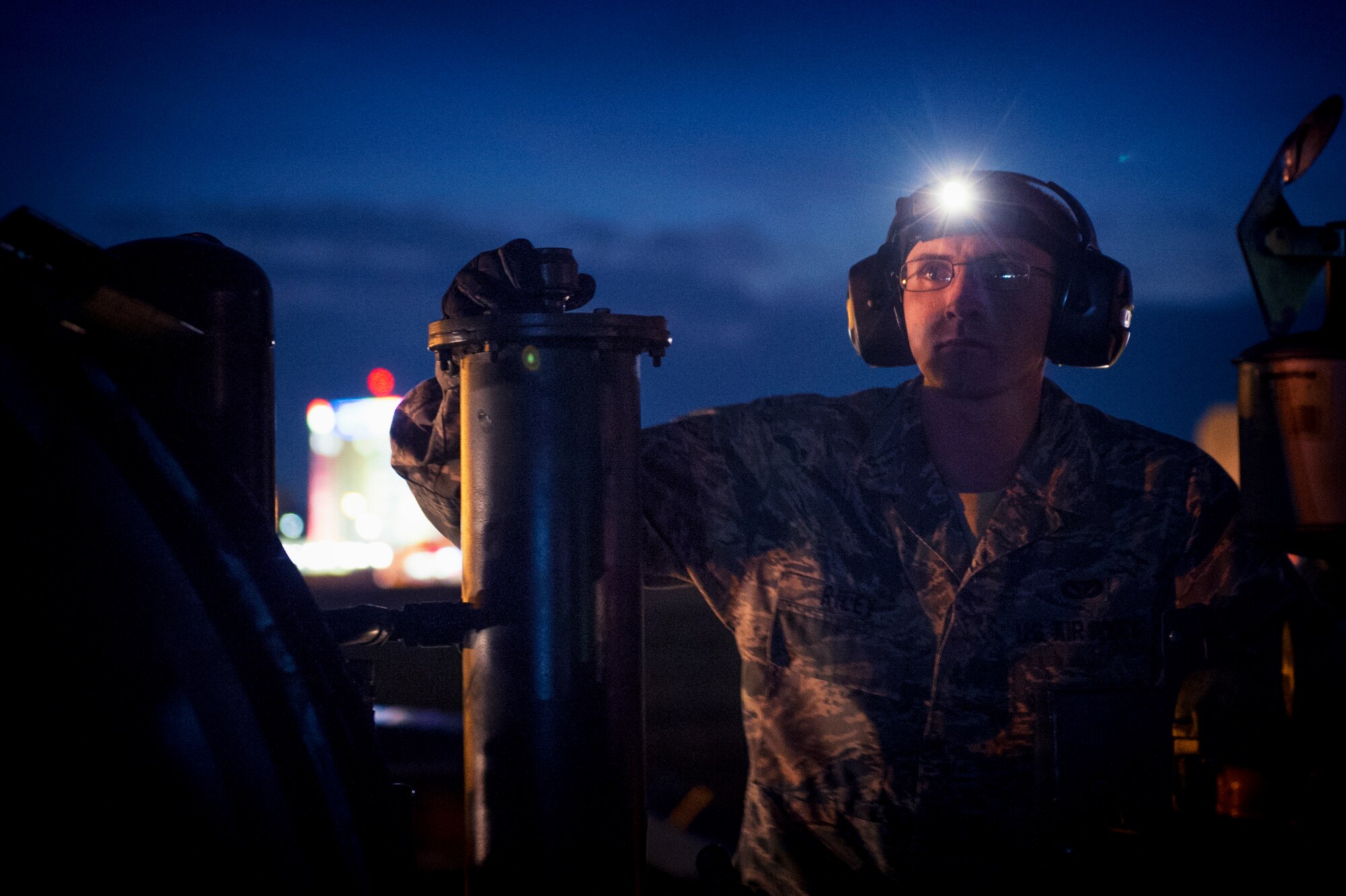 Senior Airman Jonathan Riley, 374th Civil Engineer Squadron electrical systems technician, operates a portable aircraft arresting system engine at Yokota Air Base, Japan, Nov. 6, 2015. The arresting gear of the system is used in the event of an emergency where a fighter or other properly equipped aircraft cannot stop on its own. A tailhook catches the cable stretched across the runway and hydraulic reels slowly bring the aircraft to a stop. (U.S. Air Force photo by Airman 1st Class Delano Scott/Released)