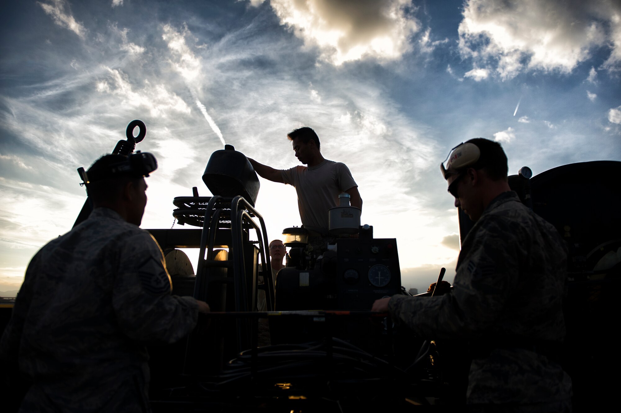 Airmen with the 374th Civil Engineer Squadron start the engine of a portable aircraft arresting system at Yokota Air Base, Japan, Nov. 6, 2015. Aircraft arresting systems are used for landing aircraft on short runways, emergencies involving brake failure, steering problems or other situations where aircraft cannot use the full length of the runway. (U.S. Air Force photo by Airman 1st Class Delano Scott/Released)