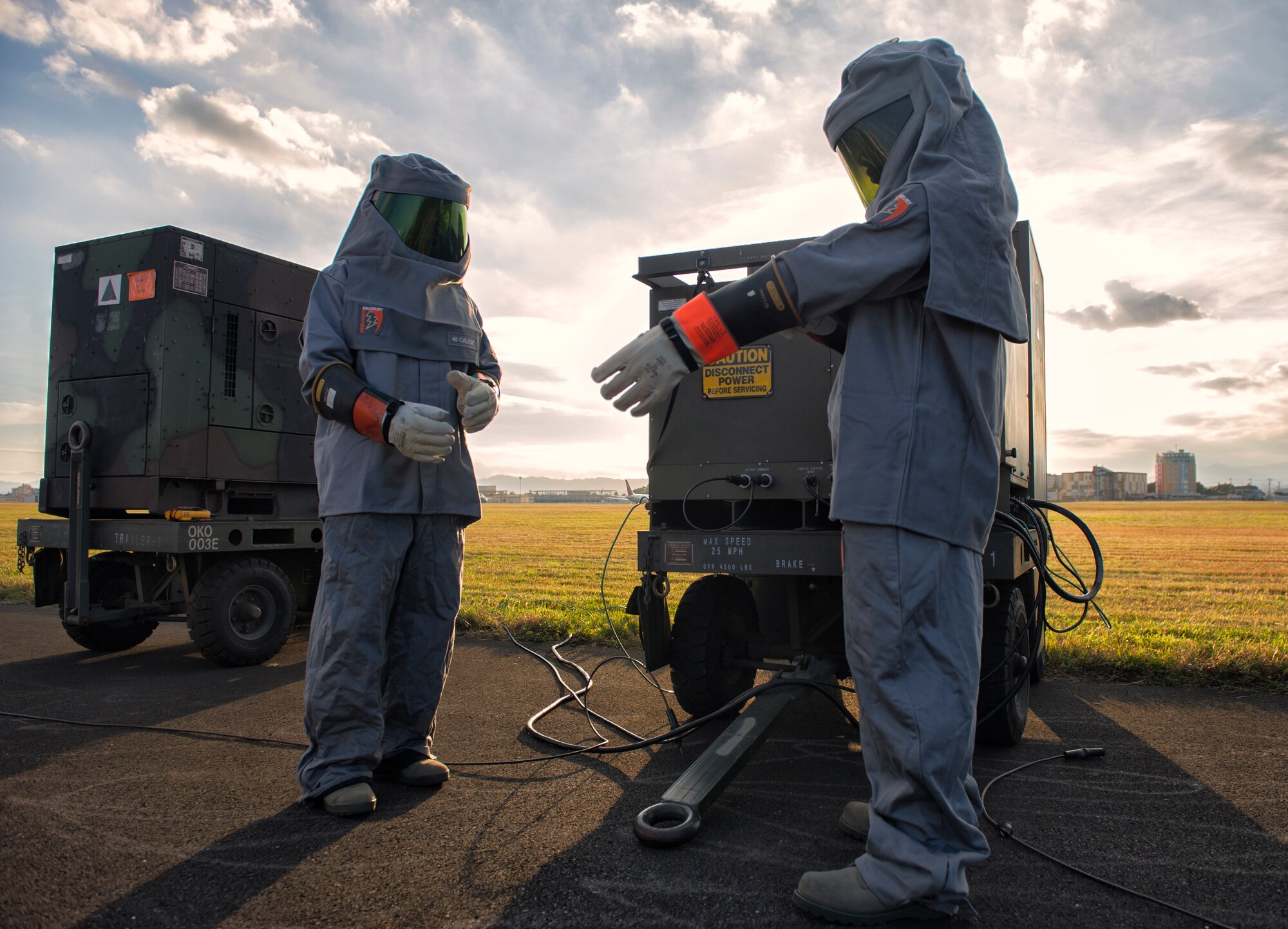 Airman 1st Class Felix Nunez and Senior Airman Ryan Mendenhall, 374th Civil Engineer Squadron electrical systems technicians, prepare to operate a portable aircraft arresting system generator at Yokota Air Base, Japan, Nov. 6, 2015. The AAS is designed to safely bring aircraft to a stop in the event of an emergency. (U.S. Air Force photo by Airman 1st Class Delano Scott/Released)