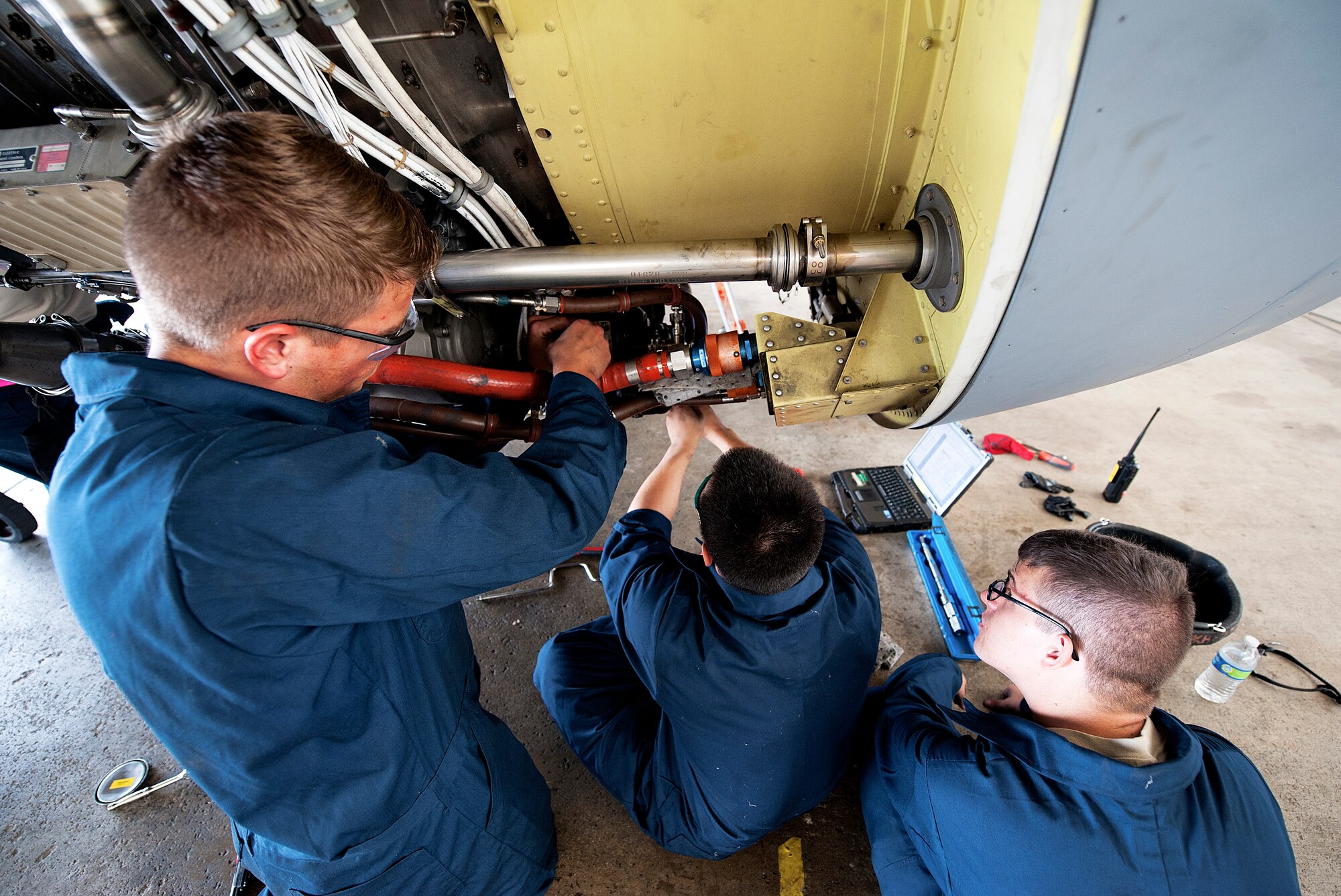 Airmen from the 909th Aircraft Maintenance Unit work on an F108 engine of a KC-135R Stratotanker, Nov. 4, 2015, at Kadena Air Base, Japan. The 909th AMU will send the replaced engine to the Tinker Air Force Base, which has a depot for broken engines. (U.S. Air Force photo by Naoto Anazawa) 