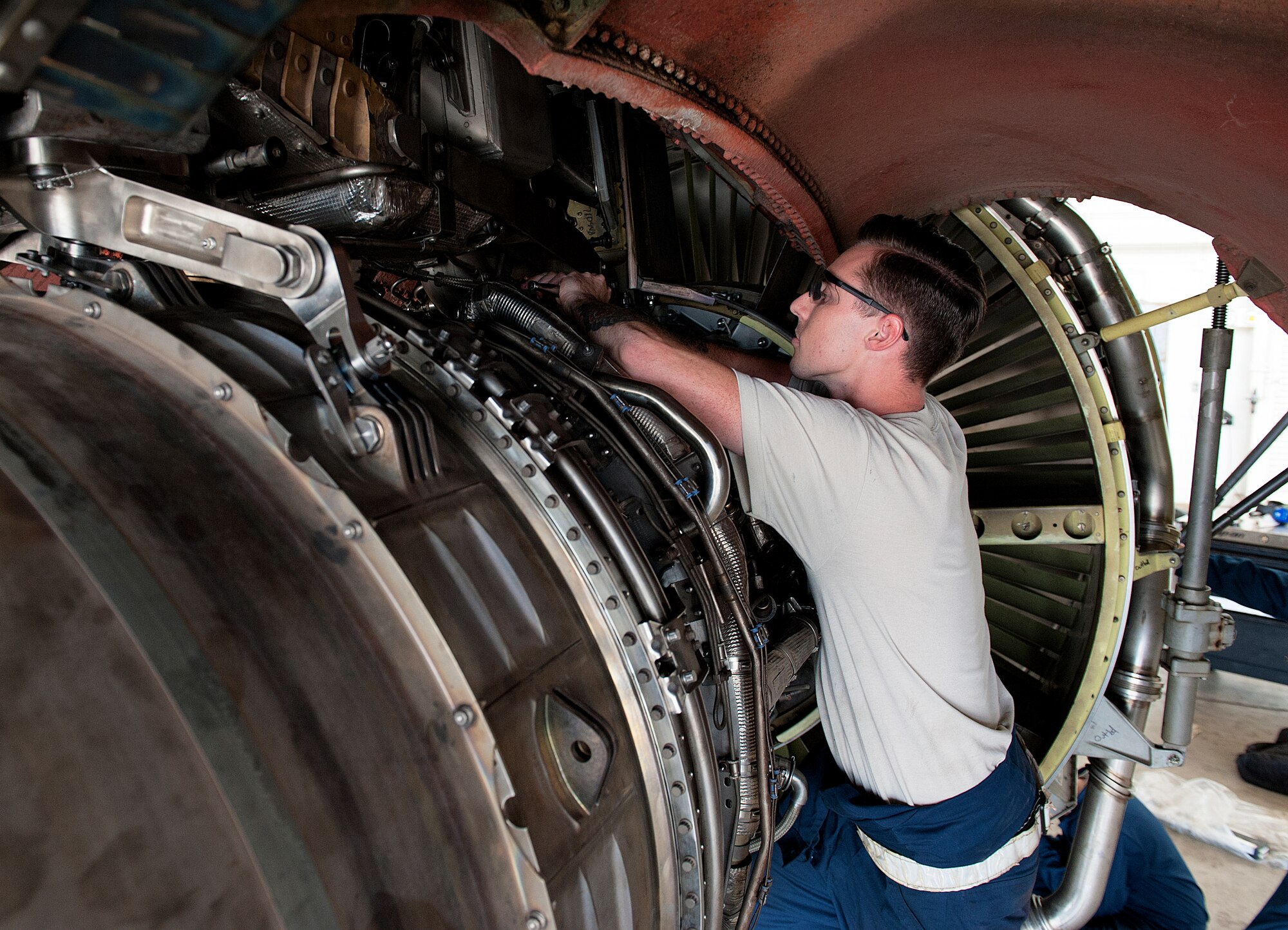U.S. Air Force Senior Airman Ty Deprez, 909th Aircraft Maintenance Unit aerospace propulsion journeyman, tightens a screw on part of the F108 engine, Nov. 4, 2015, at Kadena Air Base, Japan. Members from the 909th AMU work three shifts of six people a day to replace an F108 engine of a KC-135R Stratotanker. (U.S. Air Force photo by Naoto Anazawa)