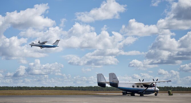 A C-146 Wolfhound passes a C-145 Skytruck while flying over the Duke Field runway Oct. 21.  The Air Force Special Operations Wing aircraft are used specifically in the training and operation of the 919th Special Operations Wing’s mission.  (U.S. Air Force photo/Tech. Sgt. Sam King)