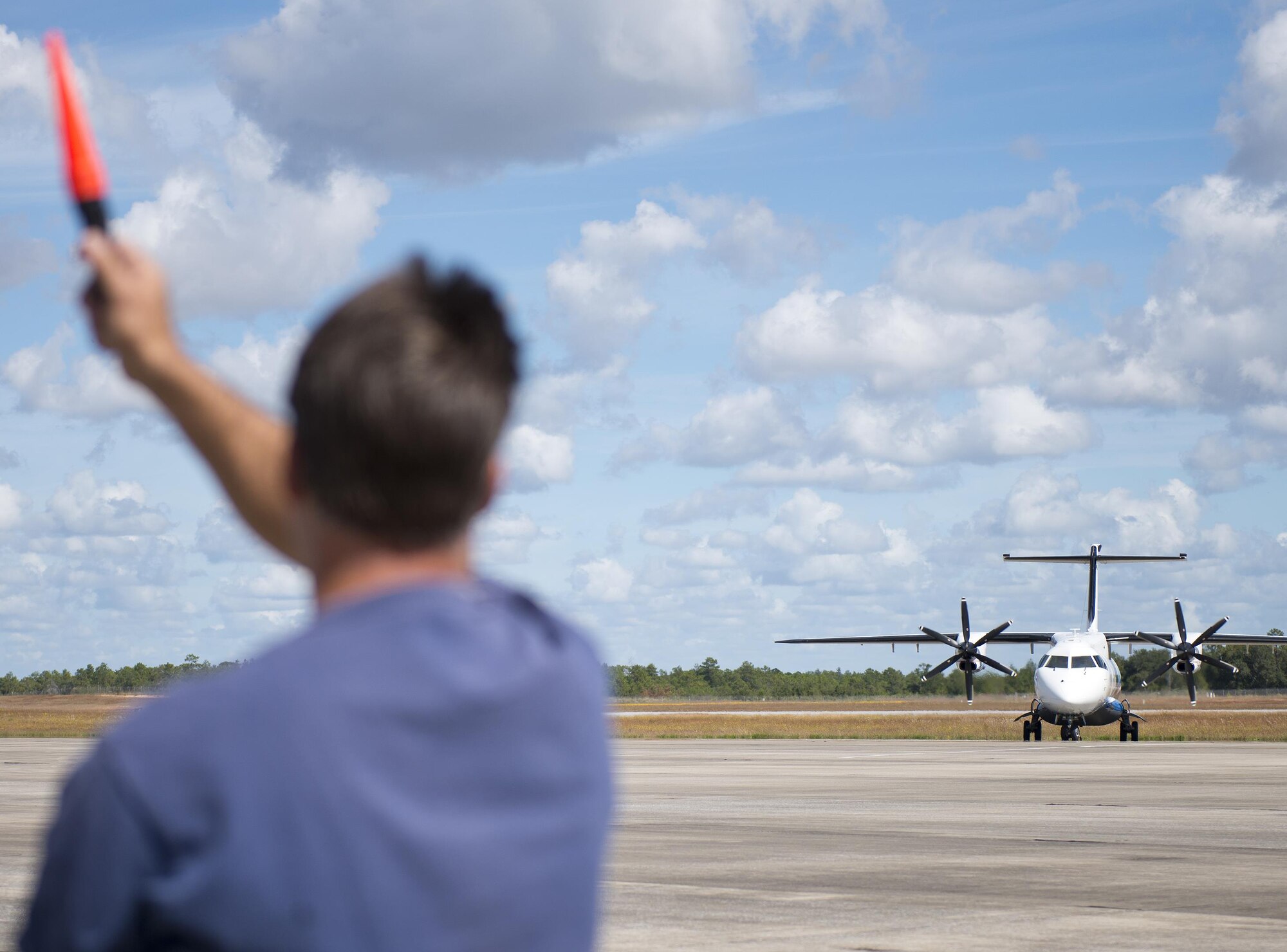 A contracted maintainer marshals in a C-146 Wolfhound after a sortie at Duke Field, Fla., Oct. 21.  The Air Force Special Operations Wing aircraft are used specifically in the training and operation of the 919th Special Operations Wing’s nonstandard aviation mission.  (U.S. Air Force photo/Tech. Sgt. Sam King)