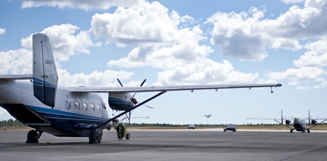 A C-146 Wolfhound comes in for a landing as C-145 Skytrucks wait for their next flight on the Duke Field flightline Oct. 21.  The Air Force Special Operations Wing aircraft are used specifically in the training and operation of the 919th Special Operations Wing’s mission.  (U.S. Air Force photo/Tech. Sgt. Sam King)
