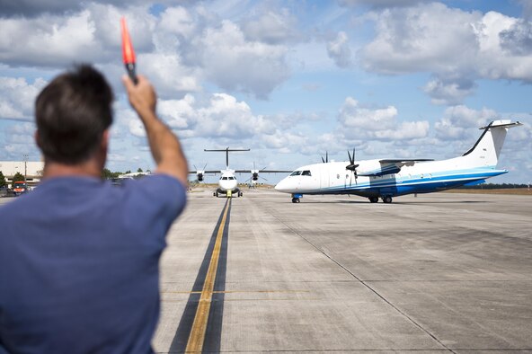A contracted maintainer marshals in a C-146 Wolfhound after a sortie at Duke Field, Fla., Oct. 21.  The Air Force Special Operations Wing aircraft are used specifically in the training and operation of the 919th Special Operations Wing’s nonstandard aviation mission.  (U.S. Air Force photo/Tech. Sgt. Sam King)