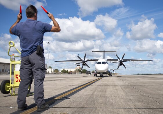 A contracted maintainer marshals in a C-146 Wolfhound after a sortie at Duke Field, Fla., Oct. 21.  The Air Force Special Operations Wing aircraft are used specifically in the training and operation of the 919th Special Operations Wing’s nonstandard aviation mission.  (U.S. Air Force photo/Tech. Sgt. Sam King)