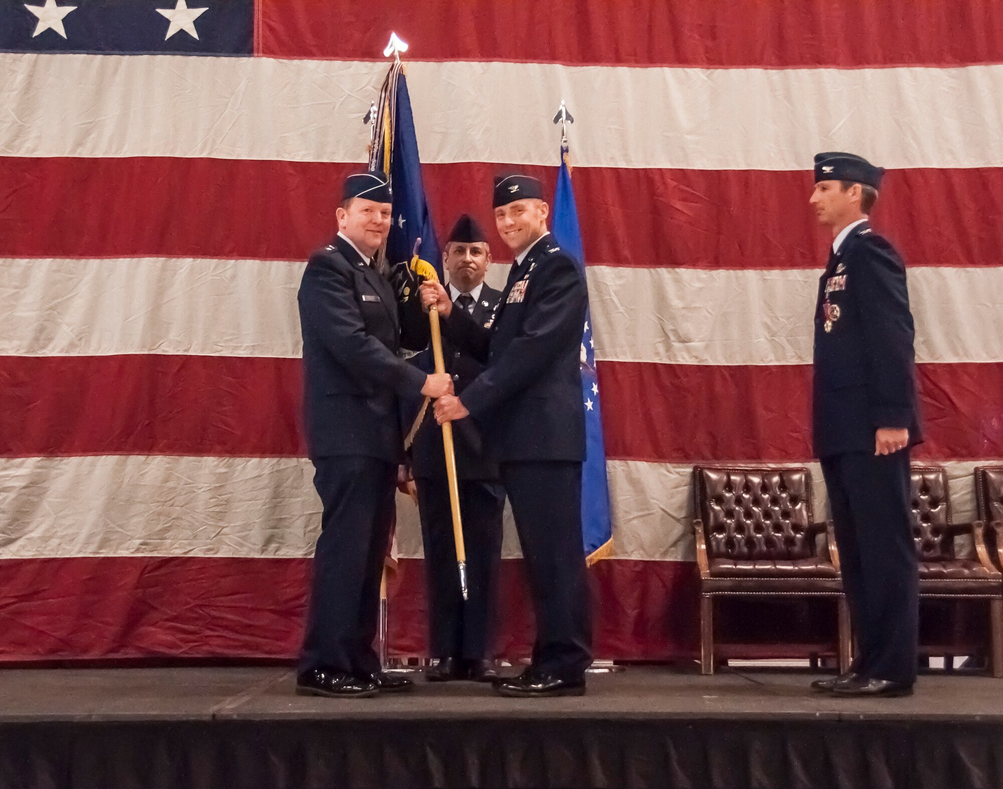 Maj. Gen. Richard Scobee, 10th Air Force commander, passes the flagship to Col. David Smith as he assumes command of the 419th Fighter Wing at a ceremony today at Hill Air Force Base. Smith will be leading nearly 1,100 reservists in the Air Force Reserve unit, including operations, maintenance, mission support, and medical personnel. (U.S. Air Force photo/Staff Sgt. Crystal Charriere)