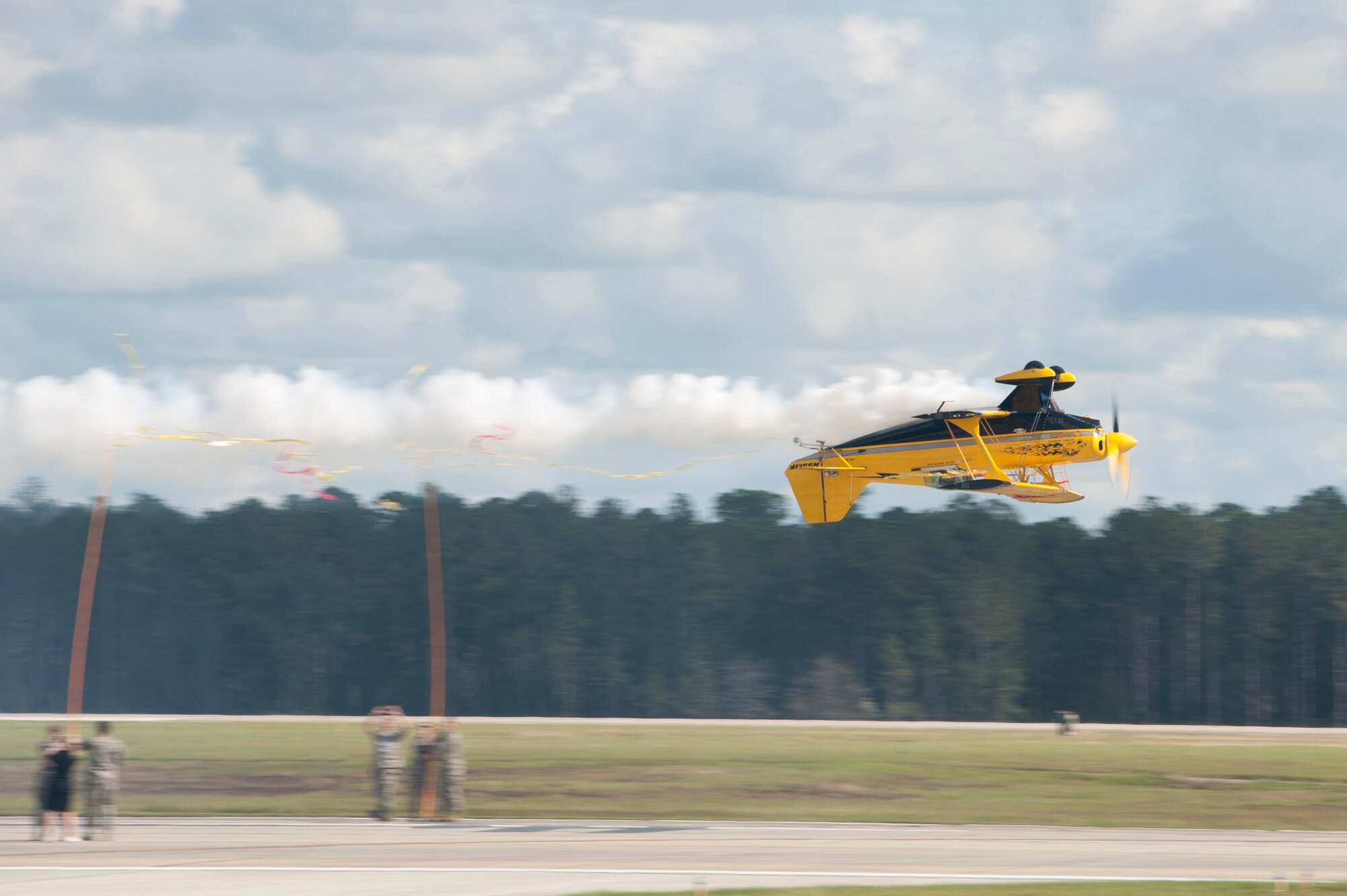 A civilian airshow performer flies upside down during the Thunder Over South Georgia, Nov. 7, 2015, at Moody Air Force Base, Ga. The pilot flew in between two poles breaking a ribbon. (U.S. Air Force photo by Airman 1st Class Kathleen D. Bryant/Released)