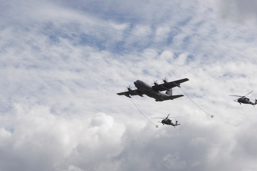 Two HH-60G Pave Hawks trail an HC-130J Combat King II during an aerial refueling demonstration as a part of the Thunder Over South Georgia Nov. 7, 2015, at Moody Air Force Base, Ga. The Combat King II is designed to conduct personnel recovery missions, provide a command and control platform, in-flight refuel helicopters and carry supplemental fuel for extending range or air refueling. (U.S. Air Force photo by Airman 1st Class Greg Nash/Released) 