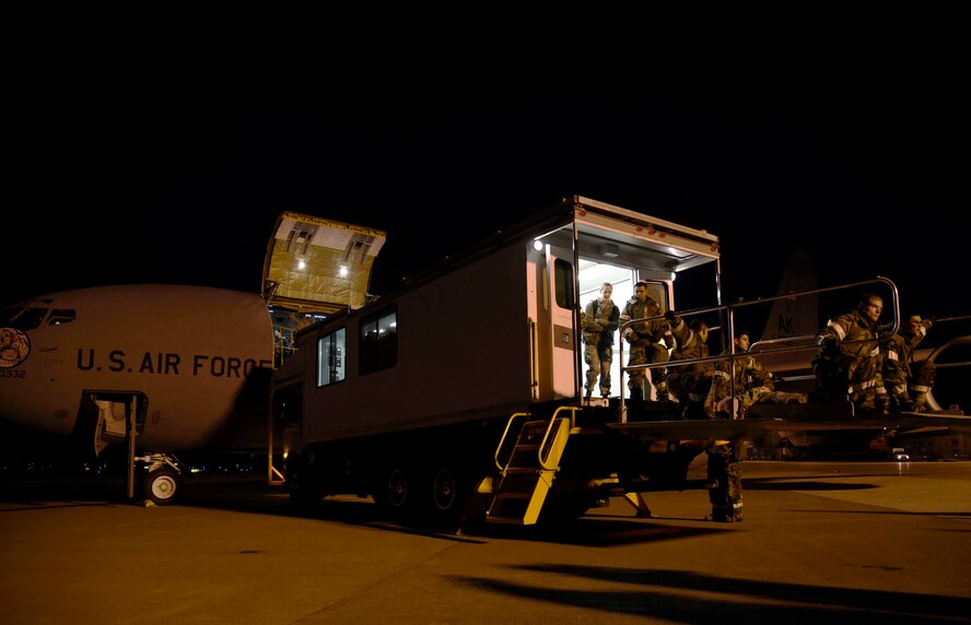 U.S. Air Force Airmen with the 35th Medical Group are lowered from a KC-135 Stratotanker at Misawa Air Base, Japan, Nov. 4, 2015. As part of exercise Vigilant Ace 16, a high deck patient loading platform was connected to the aircraft to move patients with mock injuries. During the aeromedical evacuation, medical personnel were tested on their reactions to the wounded and their ability to transport them to the hospital safely. (U.S. Air Force photo by Airman 1st Class Jordyn Fetter/Released)
