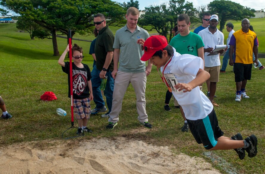 Kadena Special Olympics athlete Daiki Kinjo participates in the standing long jump skills portion during the Kadena Special Olympics Nov. 7, 2015, at Kadena Air Base, Japan. KSO is a non-profit activity managed by volunteers from around the island and funded by donations as a goodwill initiative to give back to those with special needs. (U.S. Air Force photo by Airman 1st Class Nicholas Emerick)