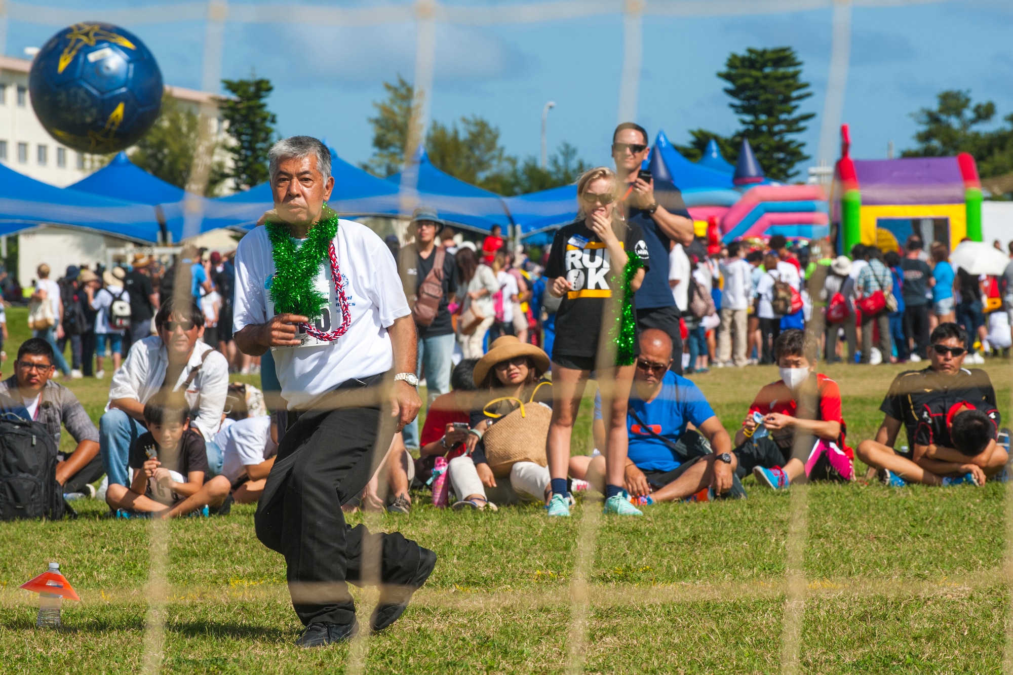 Kadena Special Olympics athlete Kunio Iho kicks a soccer ball into the net during the soccer skills event during the Kadena Special Olympics Nov. 7, 2015, at Kadena Air Base, Japan. The KSO is a one-day sporting, art and entertainment event with more than 880 athletes and artists participating in a day of competition, music and special recognition. (U.S. Air Force photo by Airman 1st Class Nicholas Emerick)