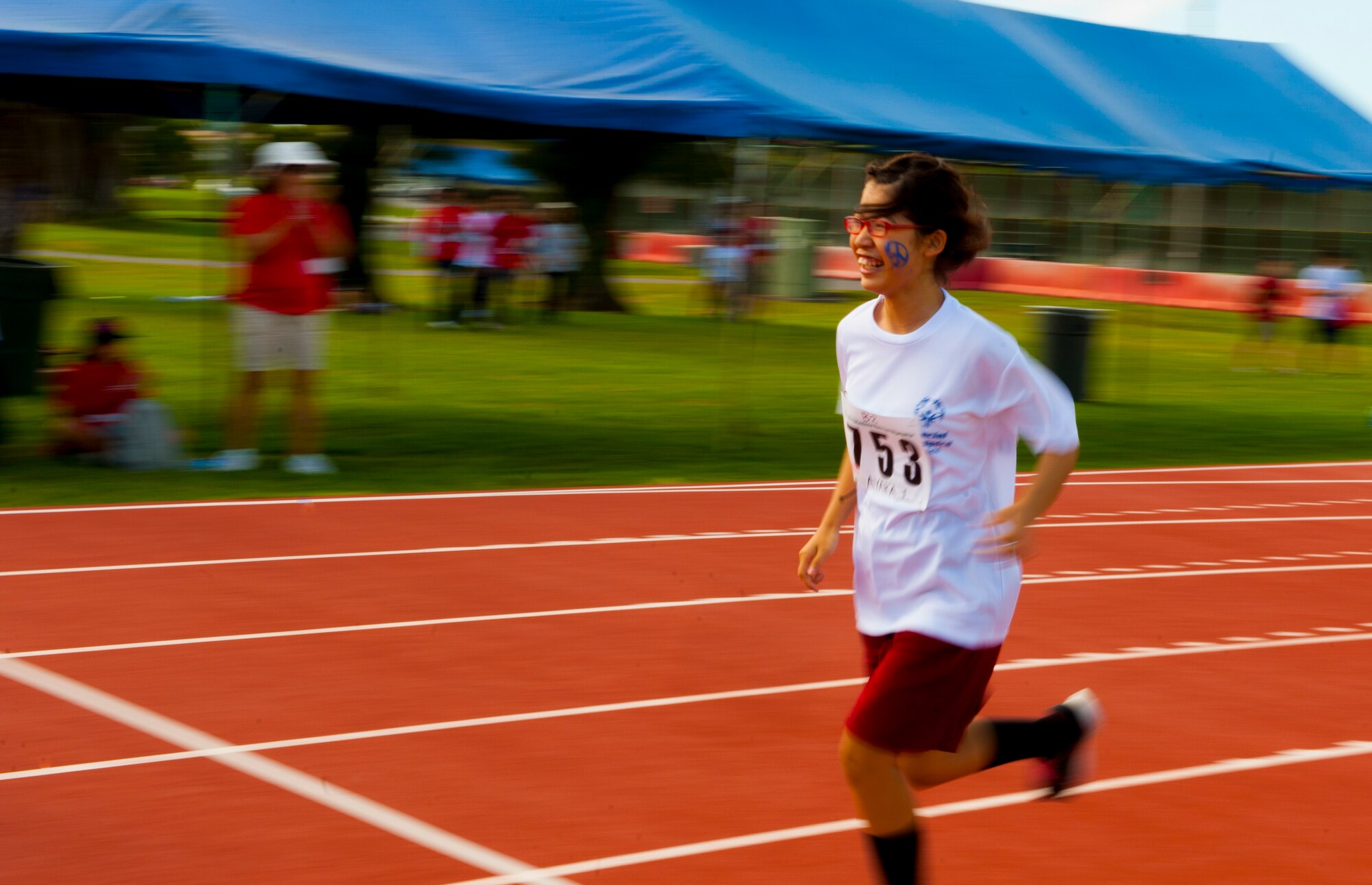 Ayaka Iha, Kadena Special Olympics athlete, runs 400 meters around the track during the Kadena Special Olympics Nov. 7, 2015, at Kadena Air Base, Japan. The KSO began in 2000 with approximately 400 athletes and 600 volunteers as an 18th Wing community goodwill initiative to strengthen U.S. - Okinawa relationships. After 16 years, the event has more than doubled in size and participation. (U.S. Air Force photo by Airman 1st Class Corey M. Pettis)