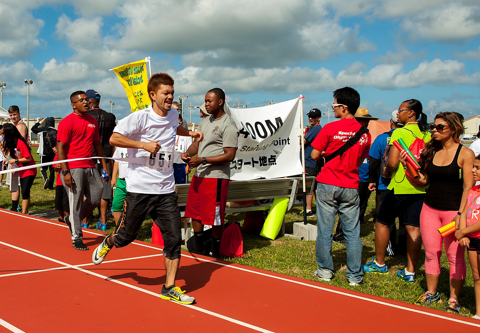 Jun Ikehara, Kadena Special Olympics athlete, crosses the finish line after a 400 meter run during the Kadena Special Olympics Nov. 7, 2015, at Kadena Air Base, Japan. The KSO is a one-day sporting, art and entertainment event with more than 880 athletes and artists participating in a day of competition, music and special recognition. (U.S. Air Force photo by Airman 1st Class Corey M. Pettis)