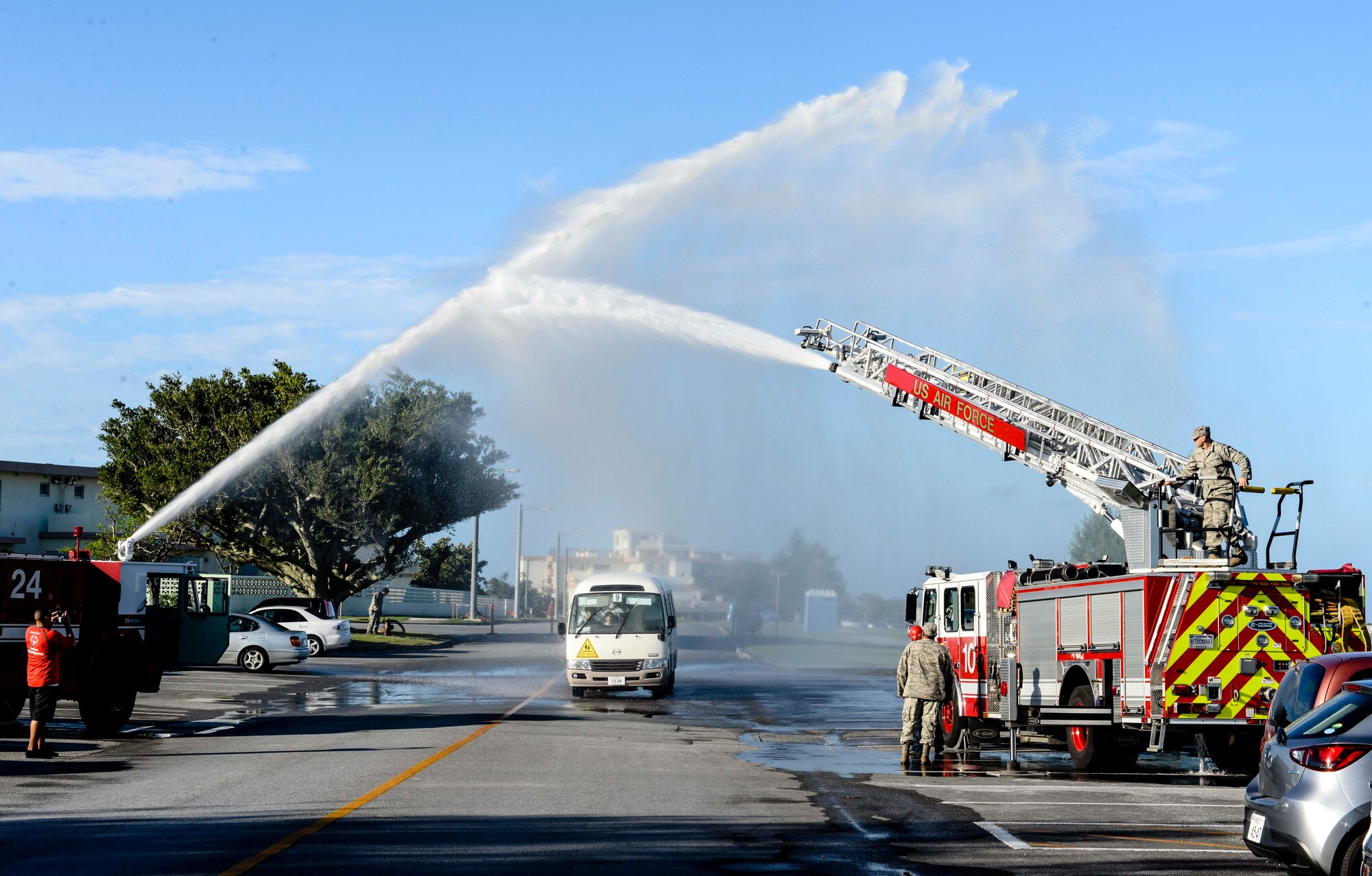 U.S. Air Force firefighters from the 18th Civil Engineer Squadron spray a water arch over a bus filled with Kadena Special Olympics athletes as they arrive at the Risner Fitness Center Sports Complex Nov. 7, 2015, at Kadena Air Base, Japan. The KSO began in 2000 with approximately 400 athletes and 600 volunteers as an 18th Wing community goodwill initiative to strengthen U.S. - Okinawa relationships. After 16 years, the event has more than doubled in size and participation. (U.S. Air Force photo by Senior Airman John Linzmeier) 