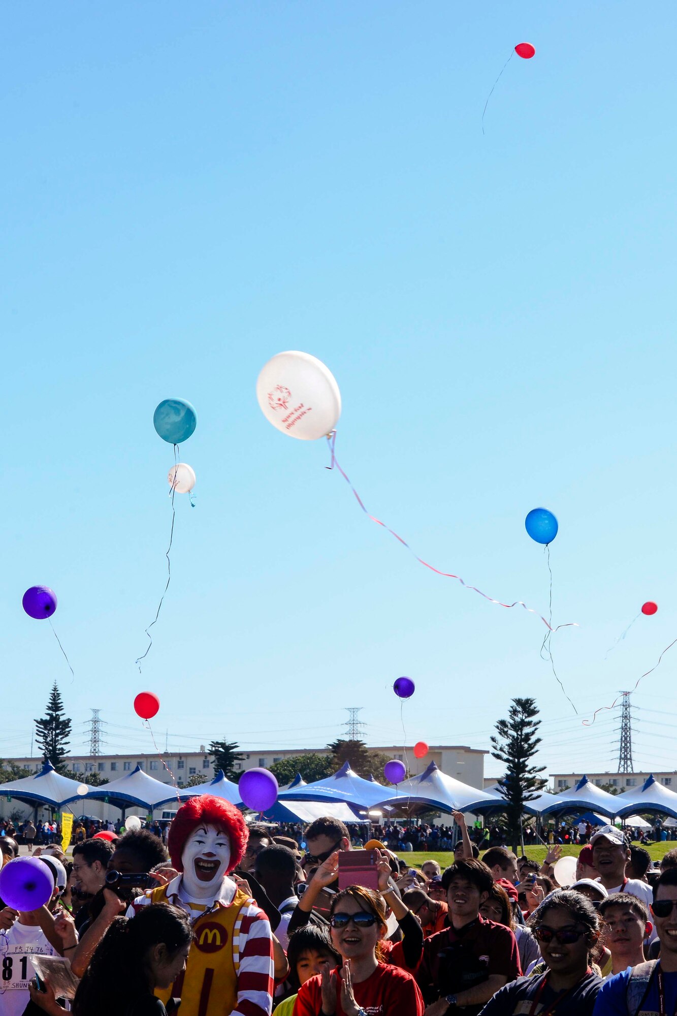 Participants, volunteers and observers of the Kadena Special Olympics release balloons into the air as the games begin Nov. 7, 2015, at Kadena Air Base, Japan. Beginning in 2000 with approximately 400 athletes and 600 volunteers, KSO is an 18th Wing community goodwill initiative to strengthen Japan-U.S. relationships. (U.S. Air Force photo by Senior Airman John Linzmeier) 
