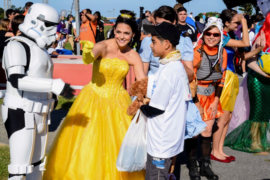 Volunteers dressed in costumes greet Kadena Special Olympics athletes as they make their way to the Risner Fitness Center Sports Complex Nov. 7, 2015, at Kadena Air Base, Japan. This year marks the 16th anniversary of KSO, a sporting event dedicated to enriching the lives of American and Okinawan special needs individuals on the island. (U.S. Air Force photo by Senior Airman John Linzmeier) 