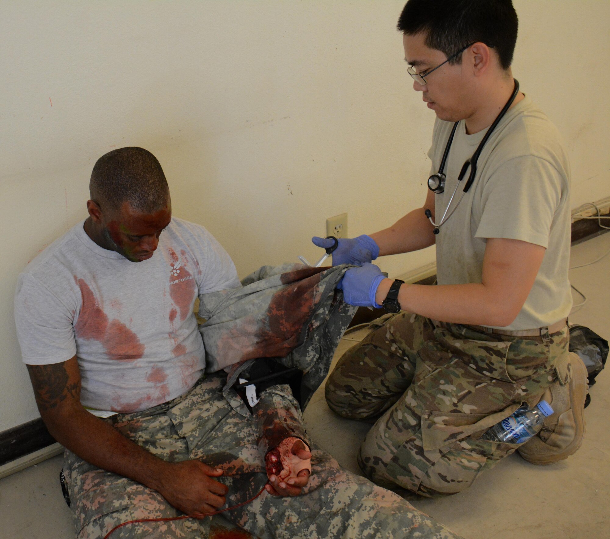 Maj. Mingen Kuo, 379th Expeditionary Medical Group staff physician, treats a patient during a medical exercise at Al Udeid Air Base, Qatar Nov. 6. The exercise provided medical teams with an opportunity to provide care for patients in a mass-casualty situation. Teams were evaluated on set up, patient movement and communication. (U.S. Air Force photo by Tech. Sgt. James Hodgman)