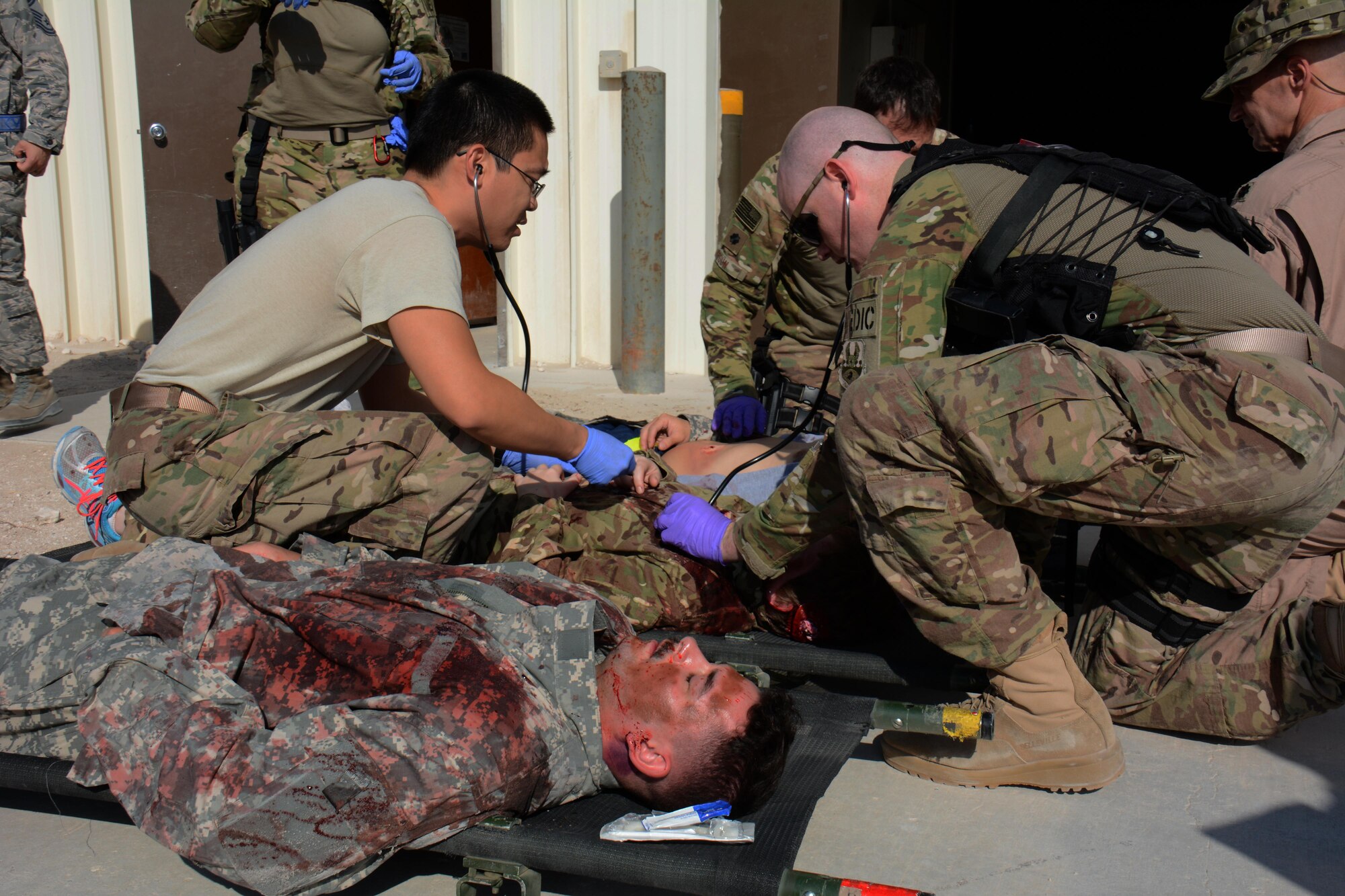 Medical teams assigned to the 379th Expeditionary Medical Group care for patients during a mass casualty exercise at Al Udeid Air Base, Qatar Nov. 6. The exercise provided medical teams with an opportunity to provide care for patients in a mass-casualty situation. Teams were evaluated on set up, patient movement and communication. (U.S. Air Force photo by Tech. Sgt. James Hodgman)