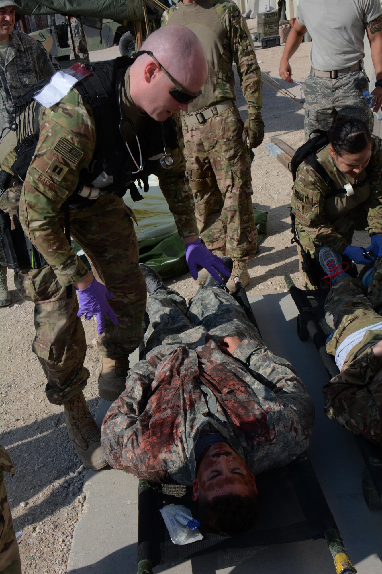 Medical teams assigned to the 379th Expeditionary Medical Group care for patients during a mass casualty exercise at Al Udeid Air Base, Qatar Nov. 6. The exercise provided medical teams with an opportunity to provide care for patients in a mass-casualty situation. Teams were evaluated on set up, patient movement and communication. (U.S. Air Force photo by Tech. Sgt. James Hodgman)