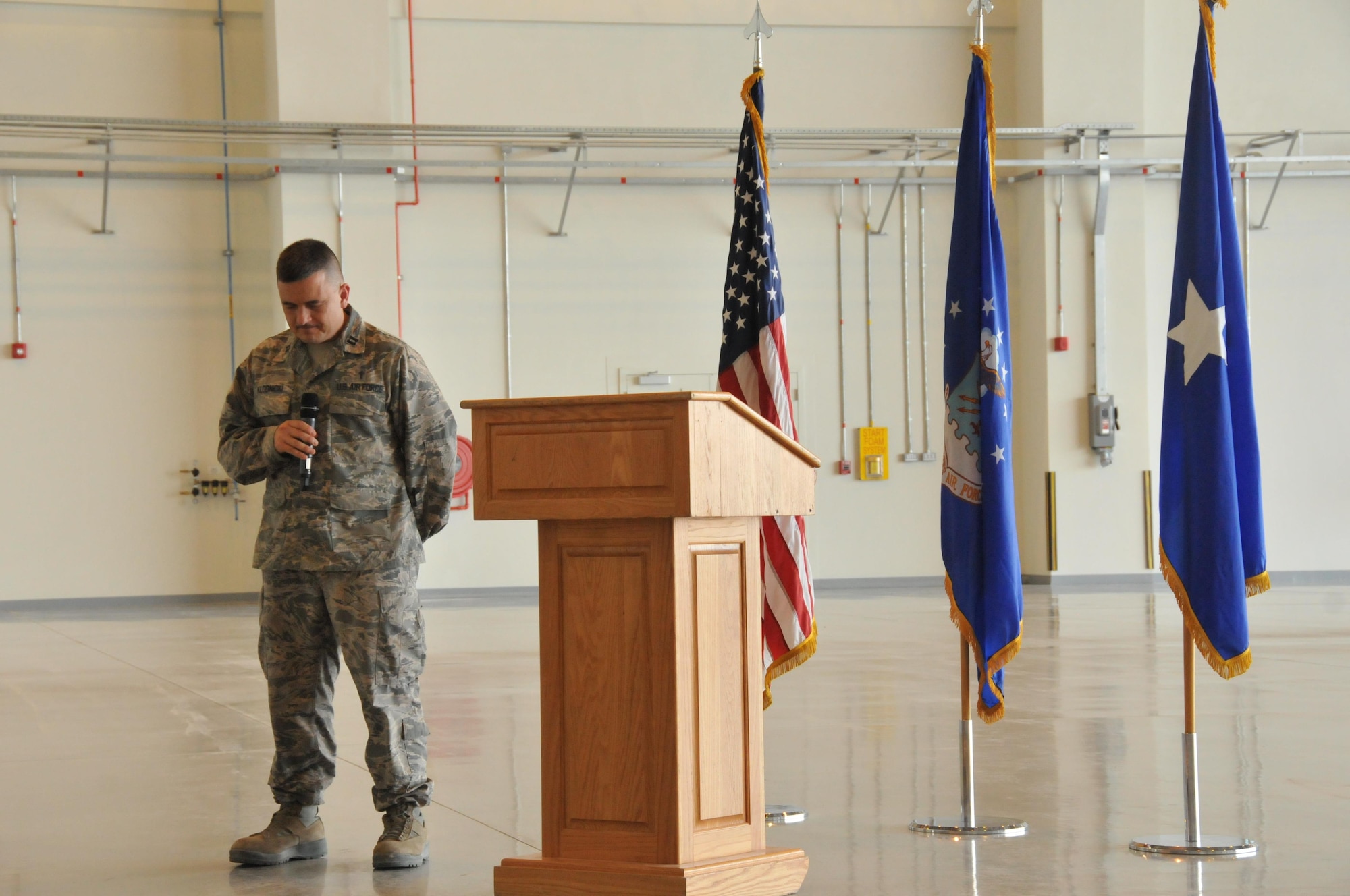 Chaplain (Capt.) Jason Klodnicki, gives the invocation before a ribbon cutting ceremony unveiling the multi-use hangar Nov.6 at Al Udeid Air Base, Qatar. The ceremony was held to celebrate the completion of the hangar. Construction began on the hangar in August 2010, but wasn’t completed until Oct. 26, 2015. The hangar will allow aircraft deployed to AUAB to be serviced in an area free from weather conditions. (U.S. Air Force photo by Tech. Sgt. Terrica Y. Jones/Released)