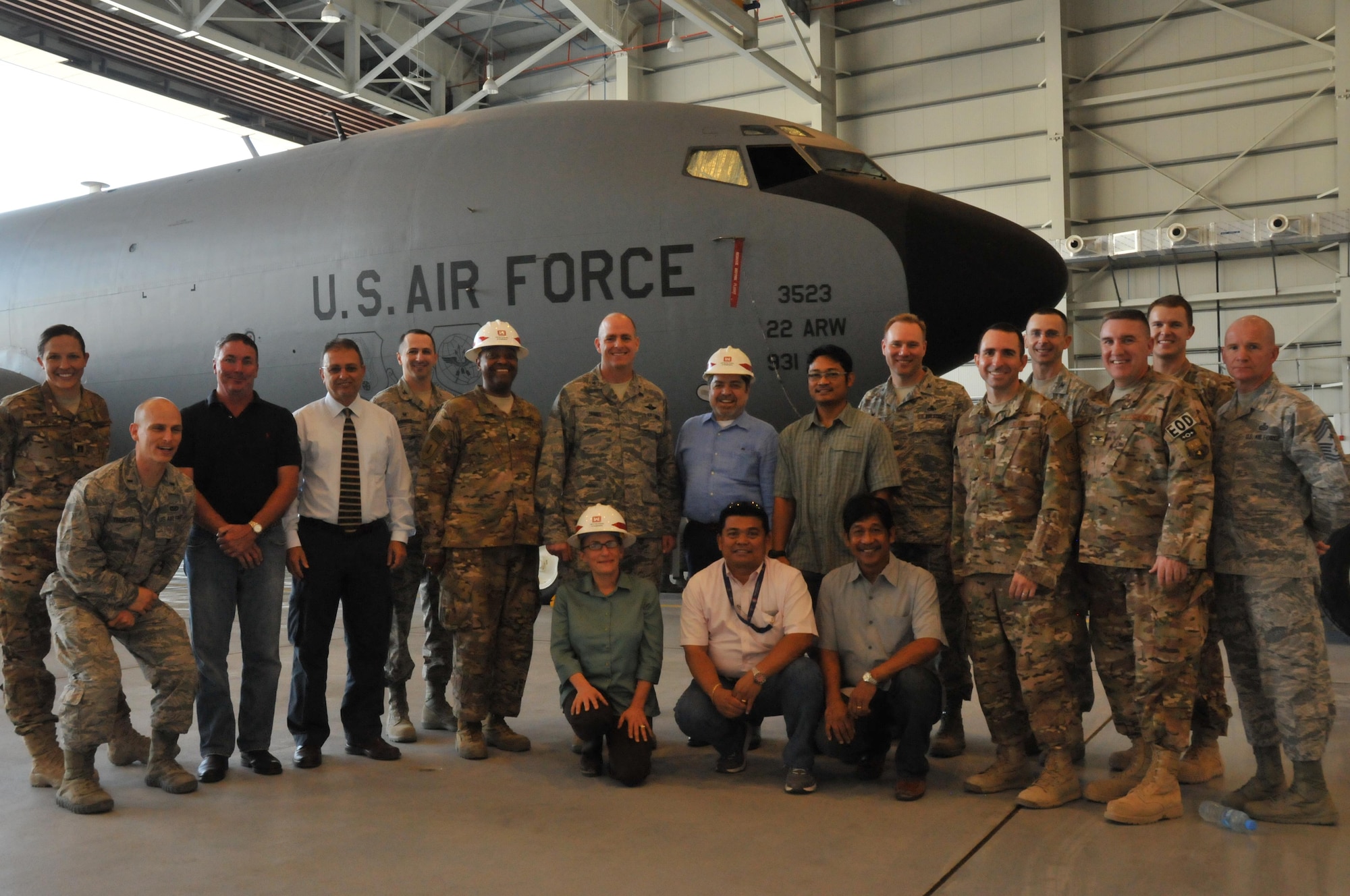Service members and contractors celebrate the completion of the multi use hanger Nov. 6 at Al Udeid Air Base, Qatar. The US Army Corps of Engineers help construct the multi use hanger that will house several planes on the flight line. Service members and contractors worked together to make an impact on air power. (U.S. Air Force photo by Tech. Sgt. Terrica Y. Jones/Released)