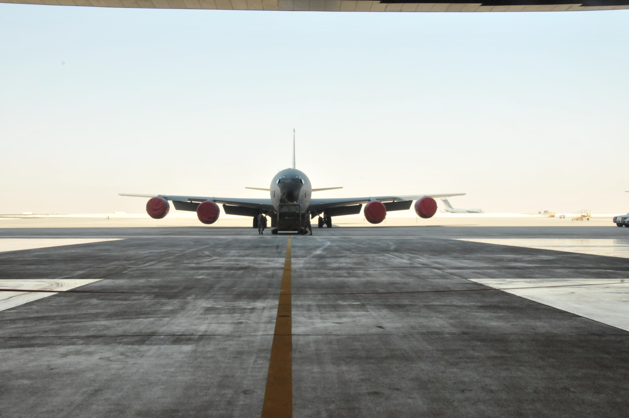 A KC-135 Stratotanker awaits on the flight line Nov. 6 at Al Udeid Air Base, Qatar before it is moved into the multi-use hangar which opened after a small ceremony. The 379th Expeditionary Maintenance Squadron prepped the KC-135 for its official arrival as service members and contractors await its entry into the multi-use hangar. (U.S. Air Force photo by Tech. Sgt. Terrica Y. Jones/Released)