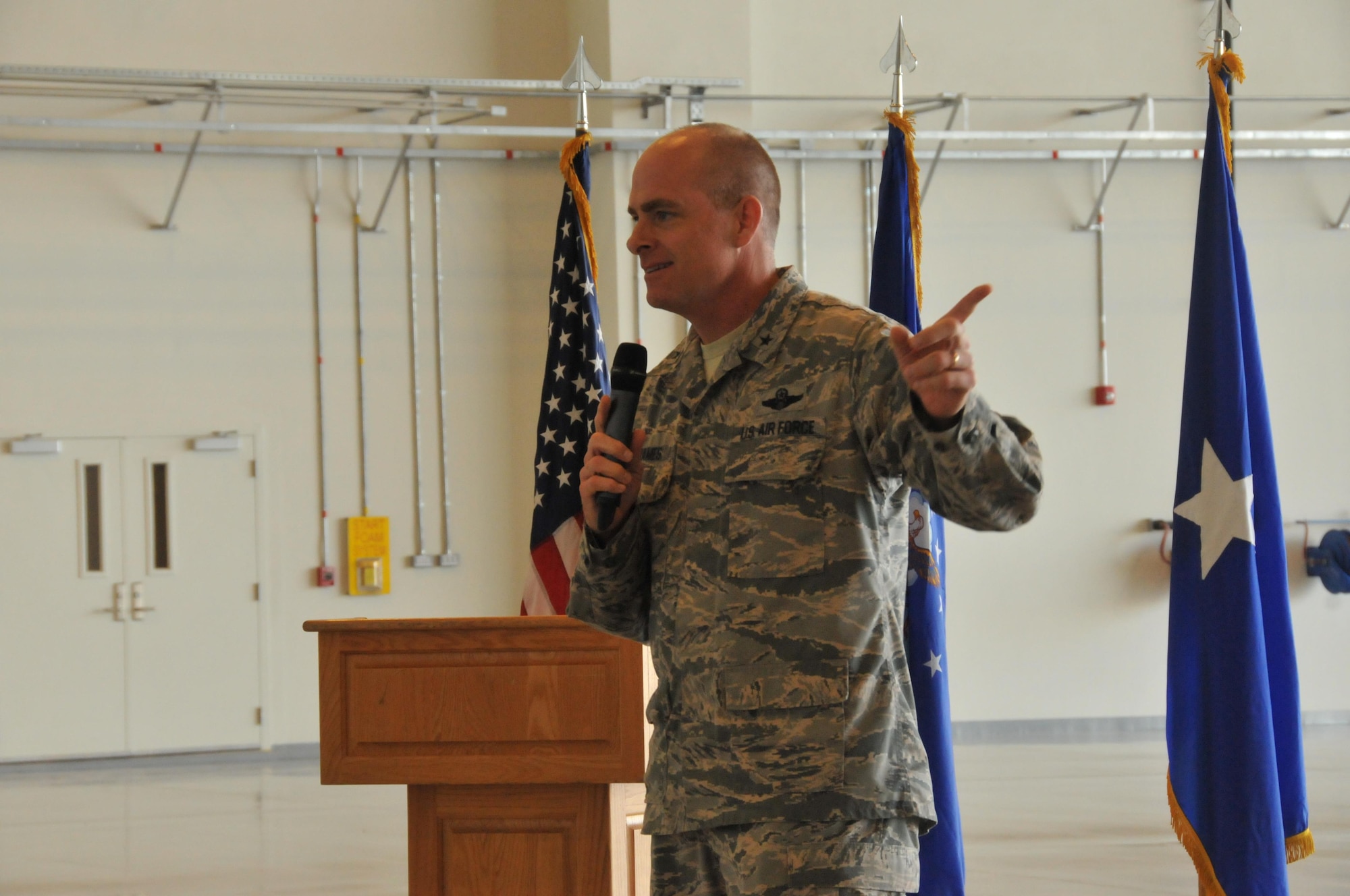 Brig. Gen.  Darren James, 379th Air Expeditionary Wing commander provides opening remarks at a ribbon cutting ceremony for the first multi-use hangar at Al Udeid Air Base, Qatar Nov. 6. The multi-use hanger will serve as protection for several planes on base. Both service members and contractors witnessed the unveiling of this facility. (U.S. Air Force photo by Tech. Sgt. Terrica Y. Jones/Released)