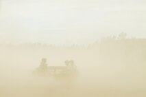 The 919th Special Operations Security Forces Squadron Airmen are barely visible while riding in a Humvee through the dusty landscape of Camp Guernsey, Wyo., Aug. 4. More than 20 Airmen went out West to help train two other Reserve security forces squadrons in ground combat and field training as part of their annual training. The 919th SOSFS Airmen lived in the makeshift camps and acted as opposing forces and local villagers interacting with the occupying security teams.  (U.S. Air Force photo/Tech. Sgt. Sam King) 