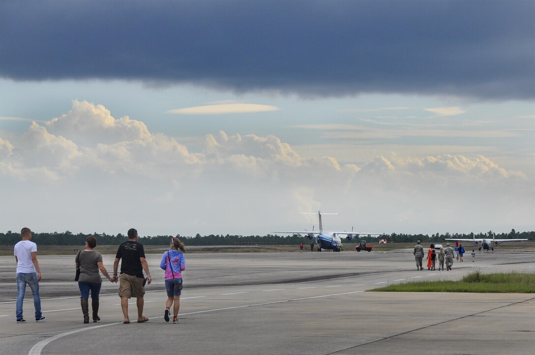 Members of the 919th Special Operations Wing and the families walk toward the wing’s aircraft for an up-close look during the Duke Field Wing Day event Nov. 7.  The 919th Special Operations Wing sets aside a special day each year to show appreciation for its reservists and their family members. Events included music, sports, children’s games, etc. (U.S. Air Force photo/Dan Neely)