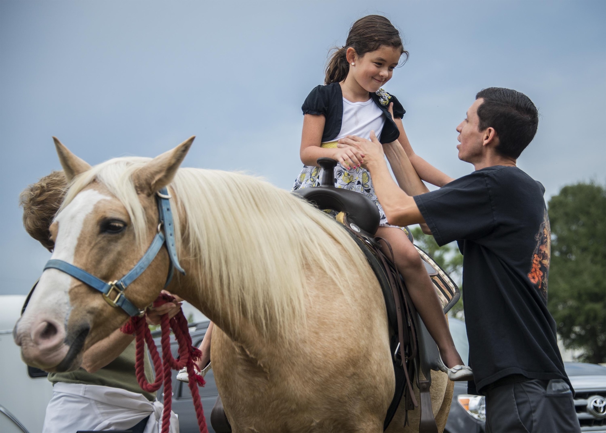 A father helps his daughter down after a pony ride during the Duke Field Wing Day event Nov. 7.  The 919th Special Operations Wing sets aside a special day each year to show appreciation for its reservists and their family members. Events included music, sports, children’s games, etc. (U.S. Air Force photo/Tech. Sgt. Cheryl Foster)