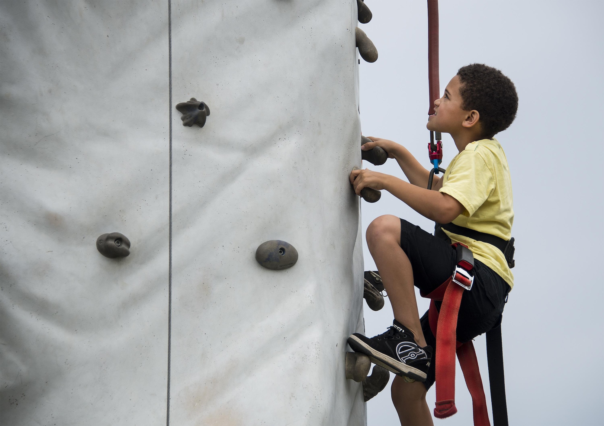 A kid climbs the rock wall during the Duke Field Wing Day event Nov. 7.  The 919th Special Operations Wing sets aside a special day each year to show appreciation for its reservists and their family members. Events included music, sports, children’s games, etc. (U.S. Air Force photo/Tech. Sgt. Cheryl Foster)