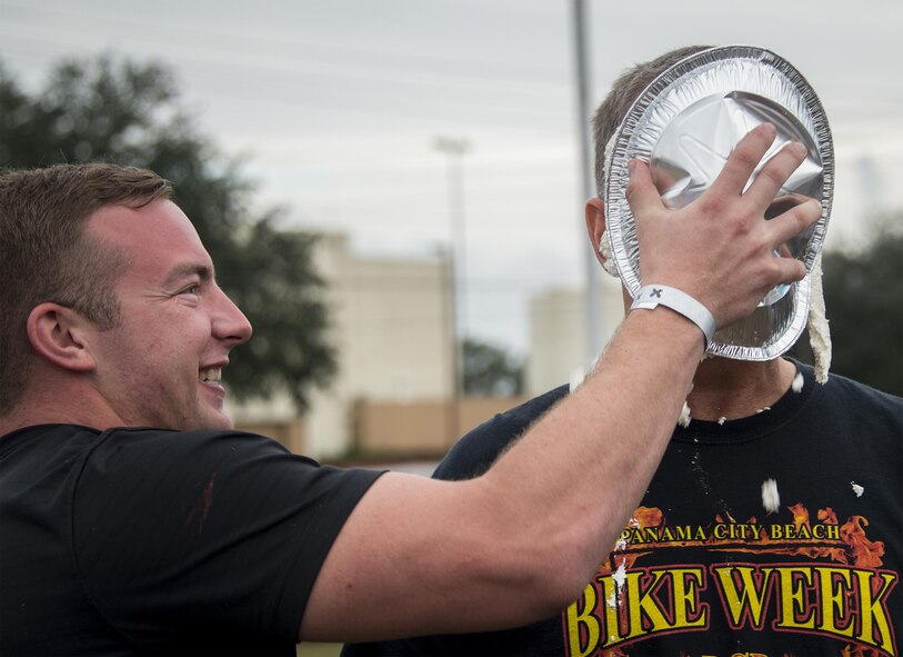 An Airman receives a pie in the face from his “wingman” during the the Duke Field Wing Day event Nov. 7.  The 919th Special Operations Wing sets aside a special day each year to show appreciation for its reservists and their family members. Events included music, sports, children’s games, etc. (U.S. Air Force photo/Tech. Sgt. Cheryl Foster)