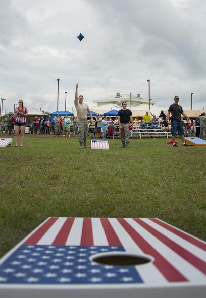 An Airman tosses a bean bag toward his target during the Duke Field Wing Day event Nov. 7.  The 919th Special Operations Wing sets aside a special day each year to show appreciation for its reservists and their family members. Events included music, sports, children’s games, etc. (U.S. Air Force photo/Tech. Sgt. Cheryl Foster)