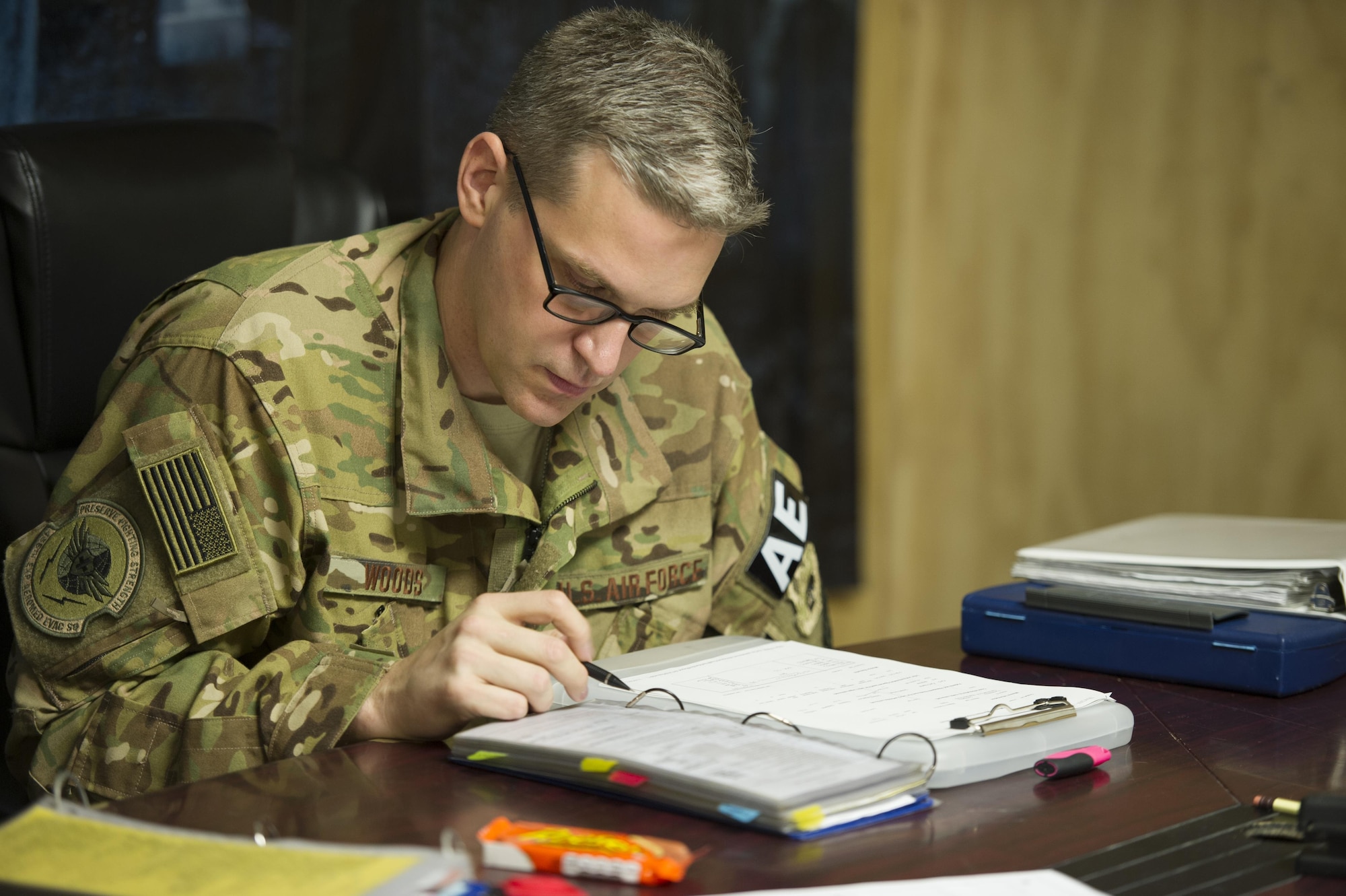 Capt. Steven Woods, 455th Expeditionary Aeromedical Evacuation Squadron flight nurse, deployed from the 43rd AES at Pope Army Airfield, N.C., reviews a checklist during a crew brief for a medevac alert at Bagram Airfield, Afghanistan, Nov. 6, 2015. The 455th EAES is tasked with moving injured and sick patients to locations with higher levels of medical care. (U.S. Air Force photo by Tech. Sgt. Robert Cloys/RELEASED)